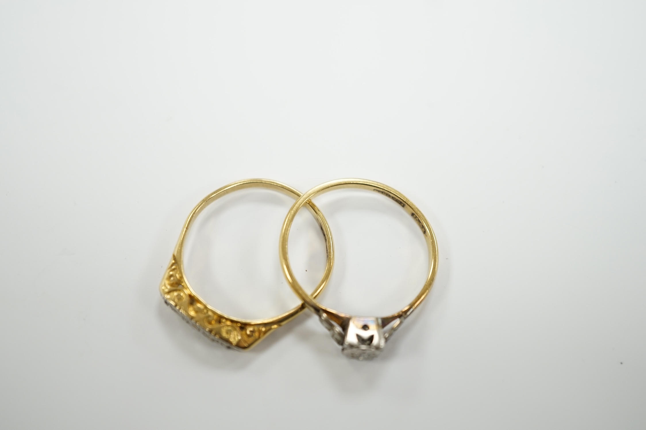 Two early to mid 20th century 18ct, plat and diamond set rings, including graduated five stone, gross weight 7.8 grams.